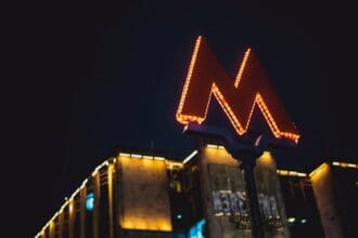 low angle photography of lighted m road sign during nighttime