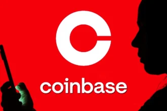 Silhouettes against red background with Coinbase logo, symbolizing crypto delisting and data breach concerns